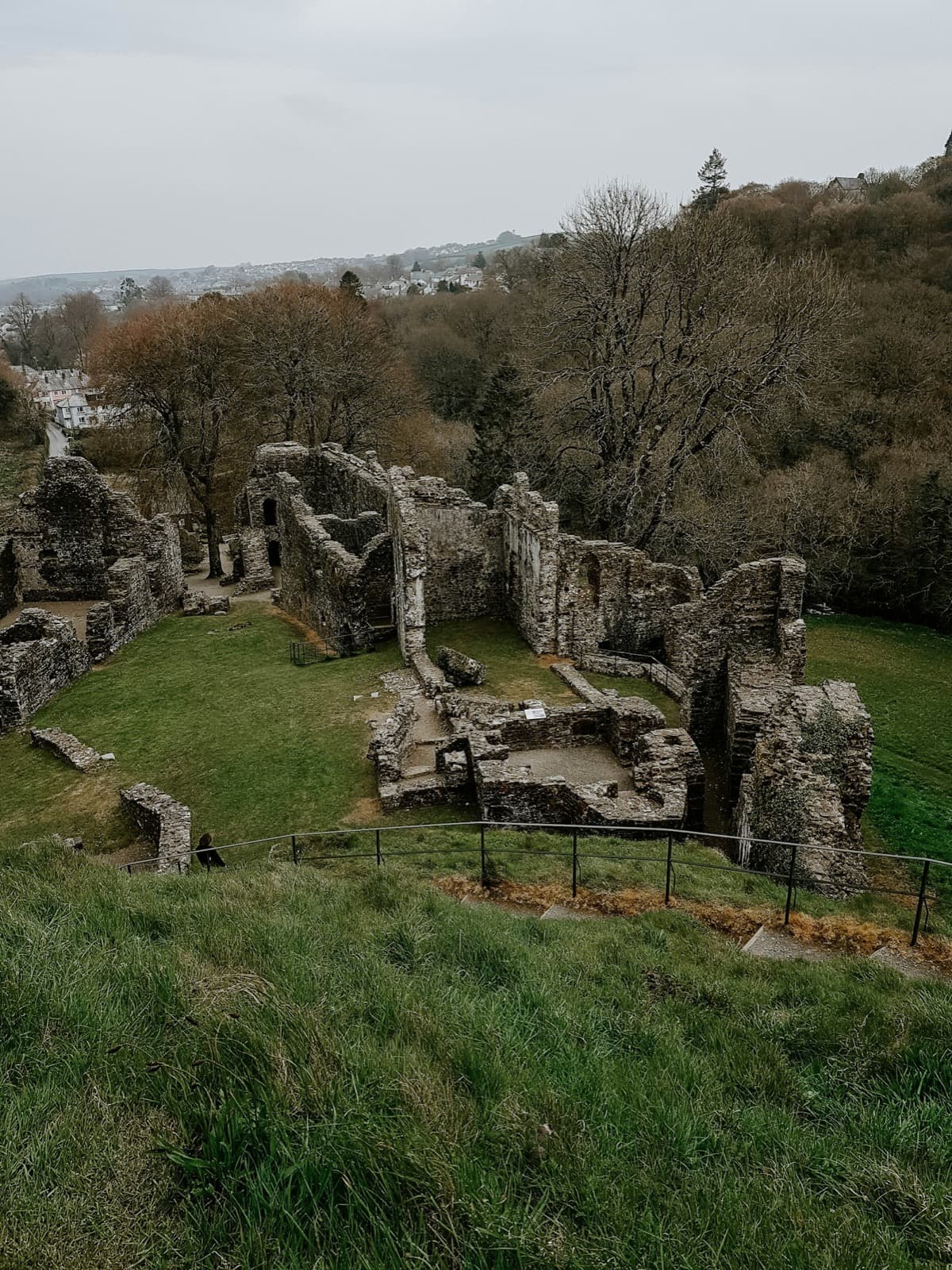 The ruins of a stone castle standing in an open field